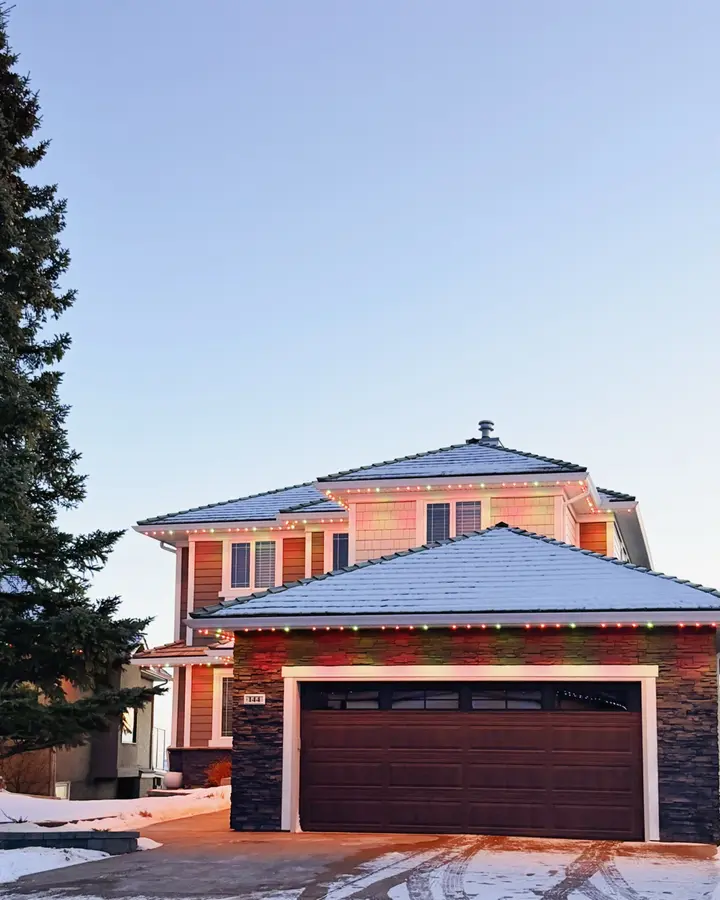 Permanent LED Christmas lights creating a festive display on a Calgary residence